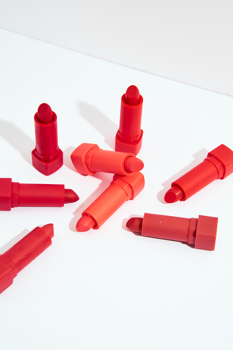 Lipsticks with Different Shades of Red on Light Background
