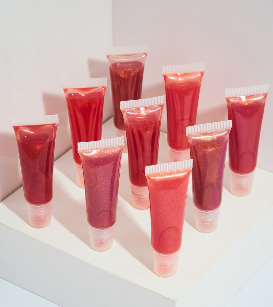 Rows of Lip Glosses on White Background